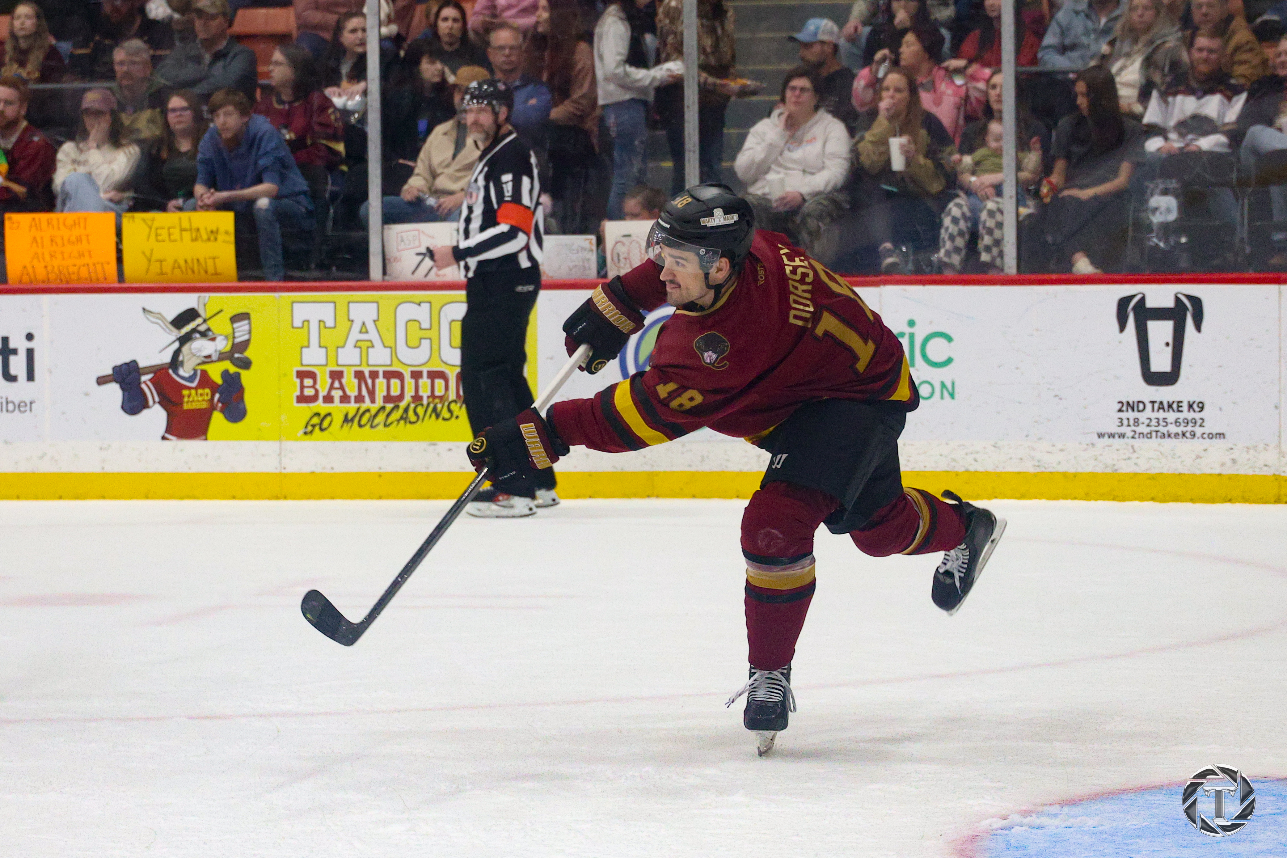Jamie Dorsey taking a shot during a hockey game.